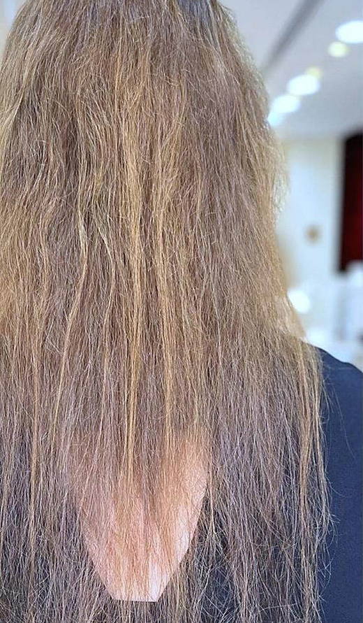 Blonde curls before extensions at PhiStudio Dubai