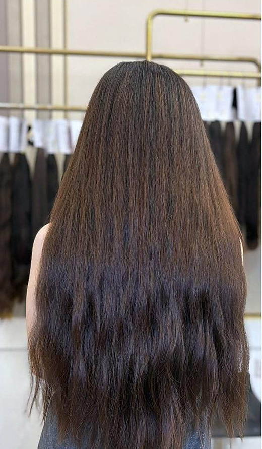 Long brown waves after extensions at PhiStudio Dubai