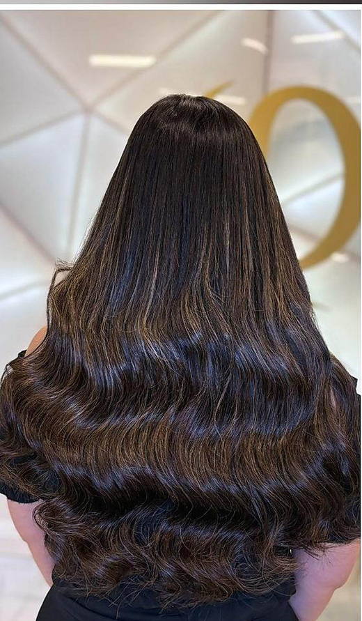 Warm brown waves after extensions at PhiStudio Dubai